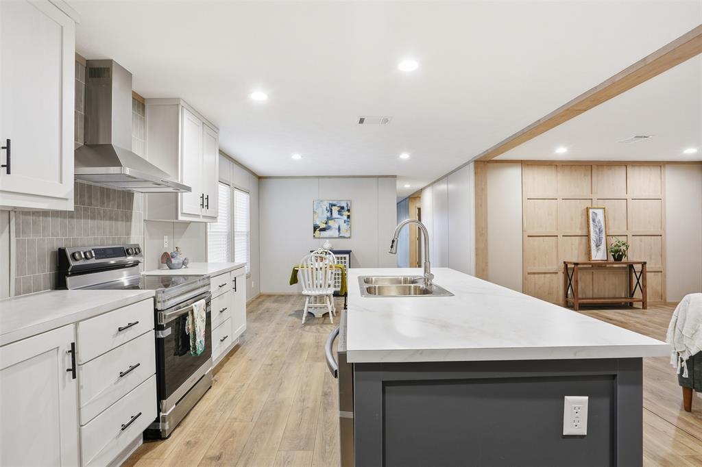 2000 Atticus Court Springtown, TX 76082 - Photo 4 of 25 a kitchen with stainless steel appliances kitchen island granite countertop a sink a stove and cabinets
