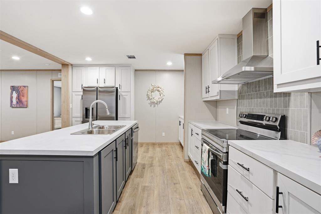 2000 Atticus Court Springtown, TX 76082 - Photo 5 of 25 a kitchen with white cabinets sink and stove