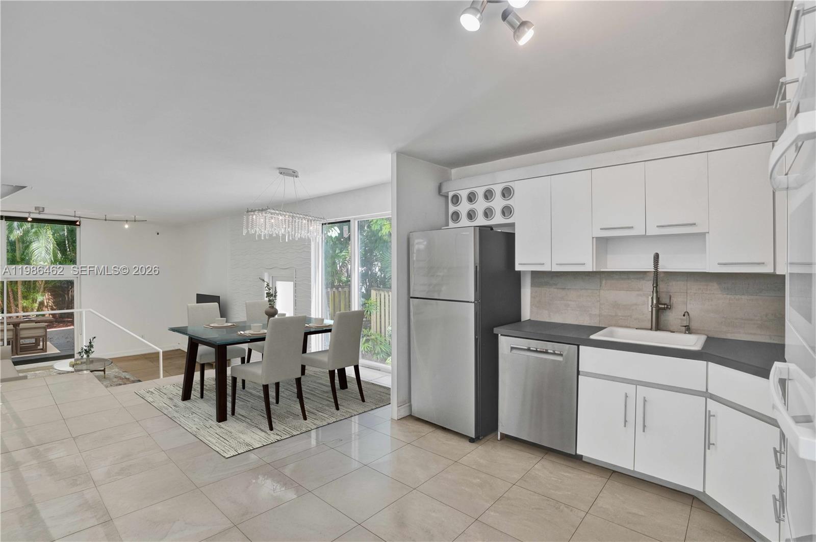 3126 Center Street, Unit 8 Coconut Grove, FL 33133 - Photo 12 of 50 a kitchen with appliances cabinets and chairs