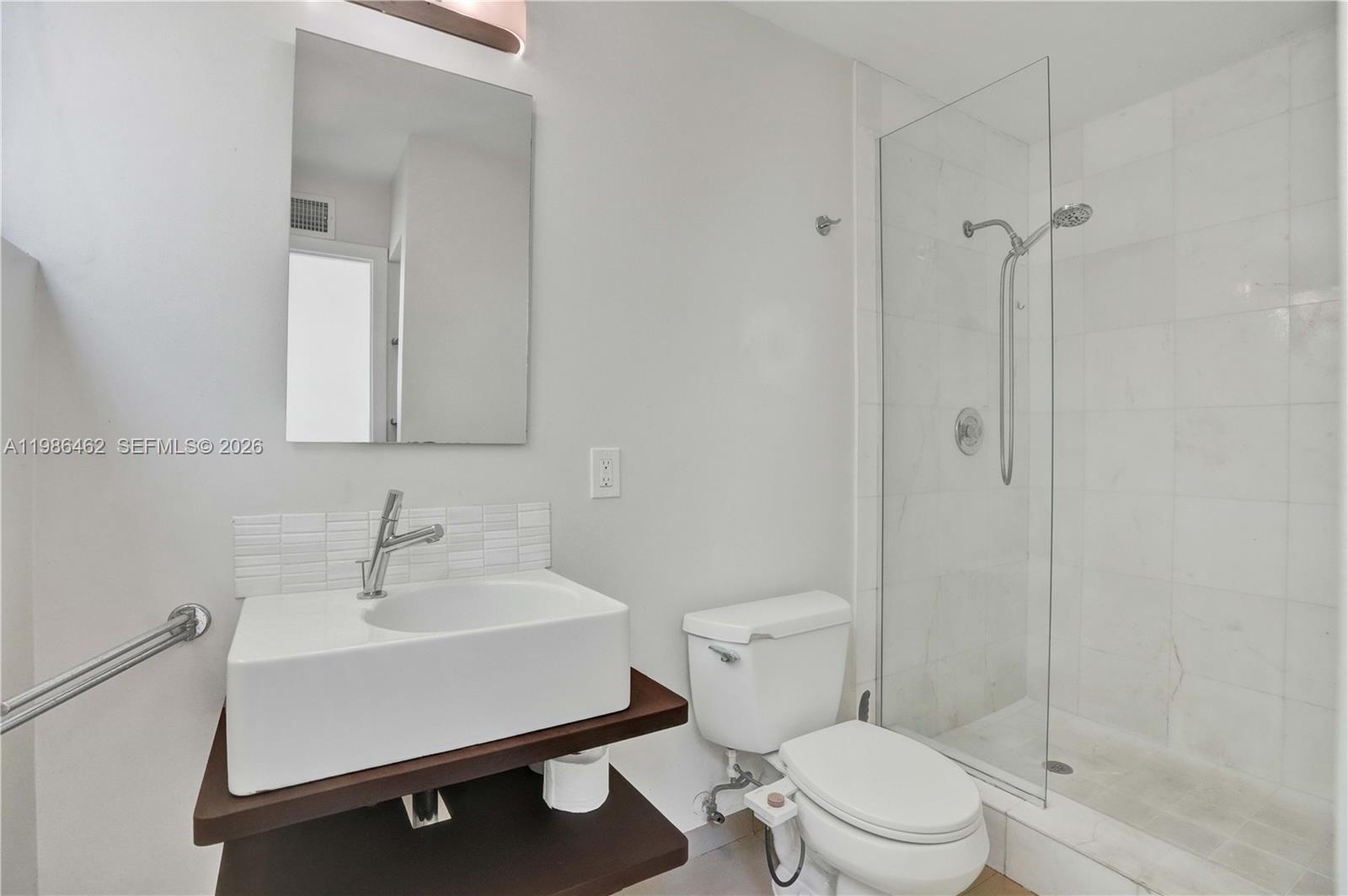 3126 Center Street, Unit 8 Coconut Grove, FL 33133 - Photo 28 of 50 a bathroom with a sink a toilet and shower
