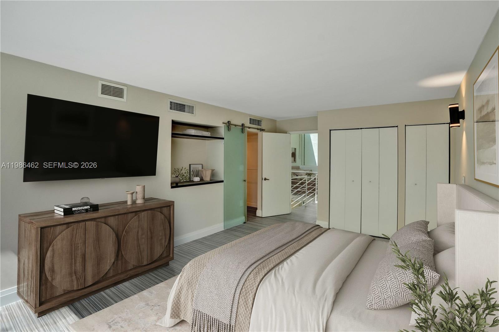 3126 Center Street, Unit 8 Coconut Grove, FL 33133 - Photo 31 of 50 a bedroom with a bed and a flat screen tv