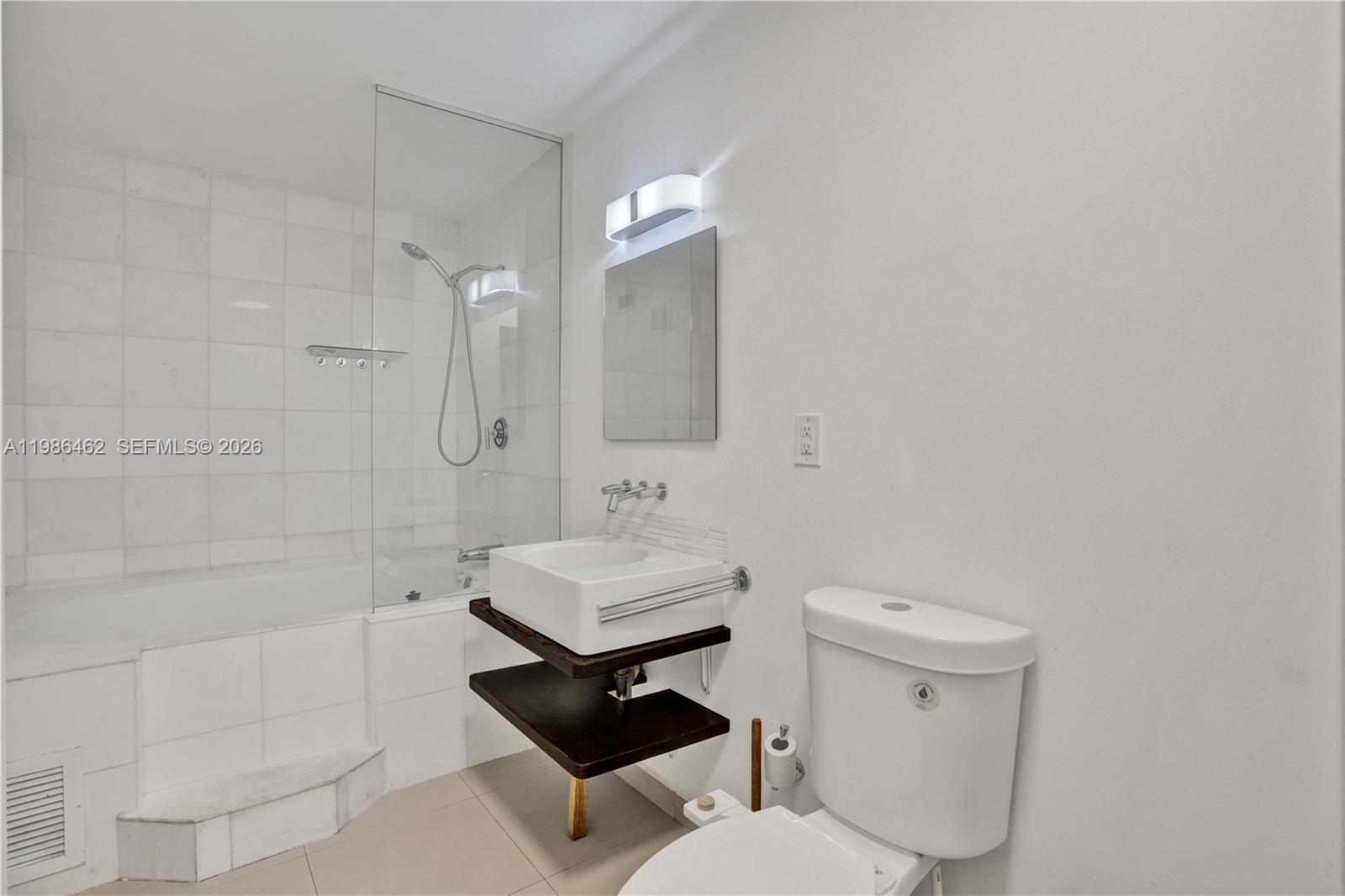 3126 Center Street, Unit 8 Coconut Grove, FL 33133 - Photo 34 of 50 a bathroom with a toilet a sink and bathtub
