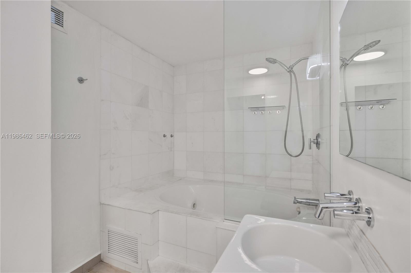 3126 Center Street, Unit 8 Coconut Grove, FL 33133 - Photo 35 of 50 a bathroom with a white shower a sink and vanity