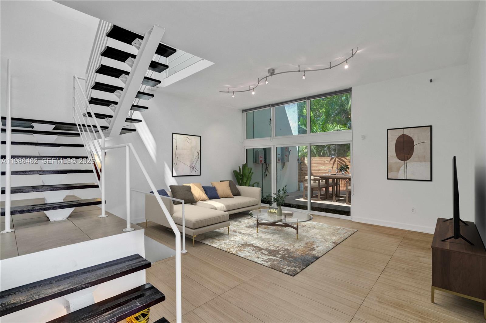 3126 Center Street, Unit 8 Coconut Grove, FL 33133 - Photo 6 of 50 a living room with furniture and a floor to ceiling window