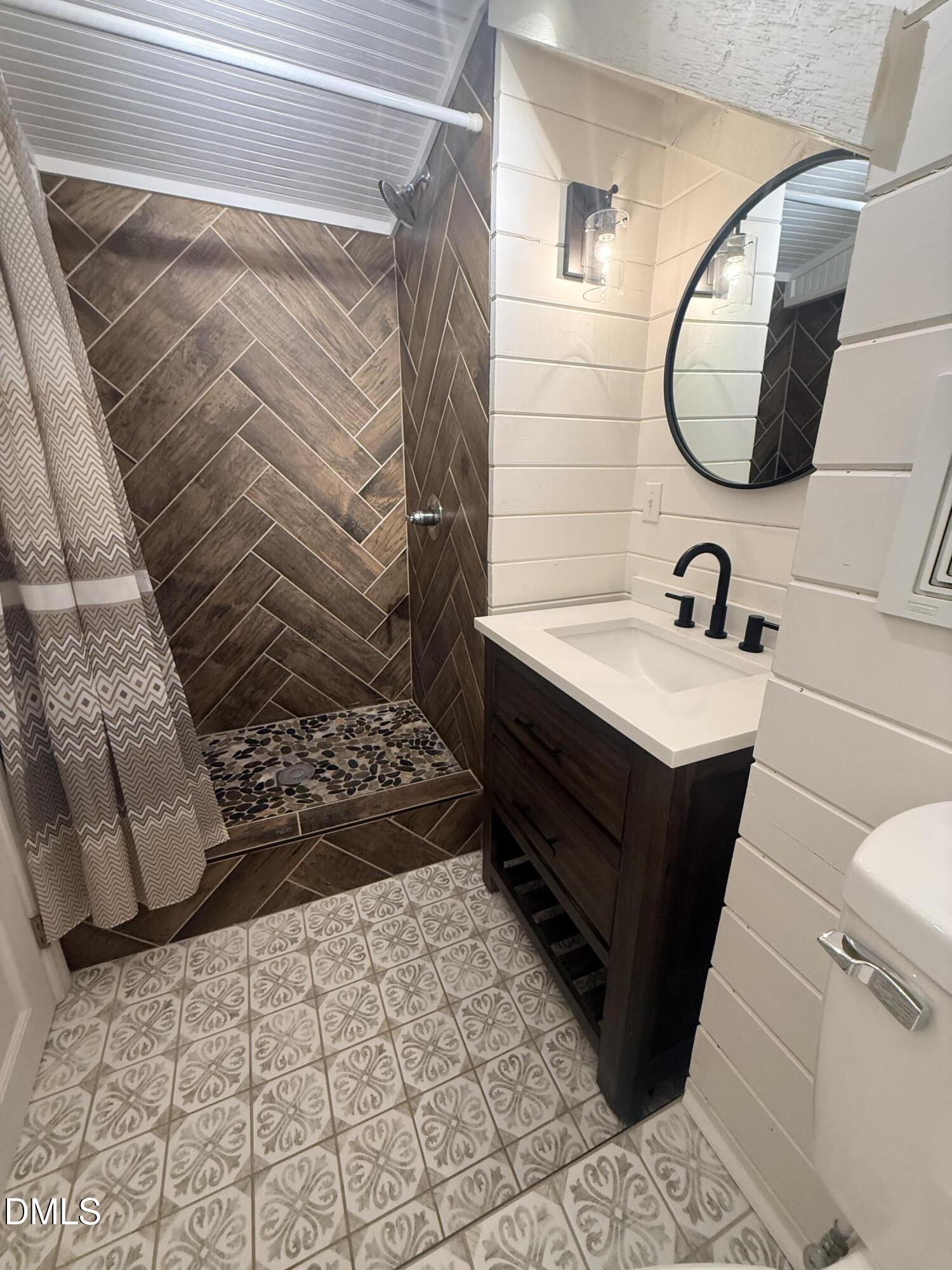 327 Shady Oak Road Roxboro, NC 27574 - Photo 45 of 62 a bathroom with a sink and a mirror
