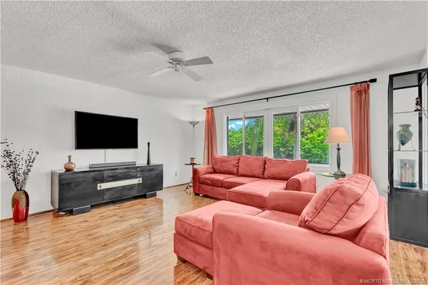 a very nice looking dining room with furniture window and wooden floor