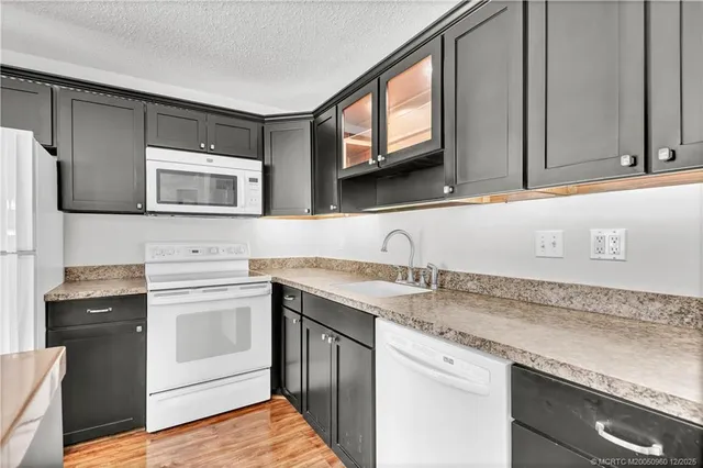 a dining room with furniture a chandelier and wooden floor