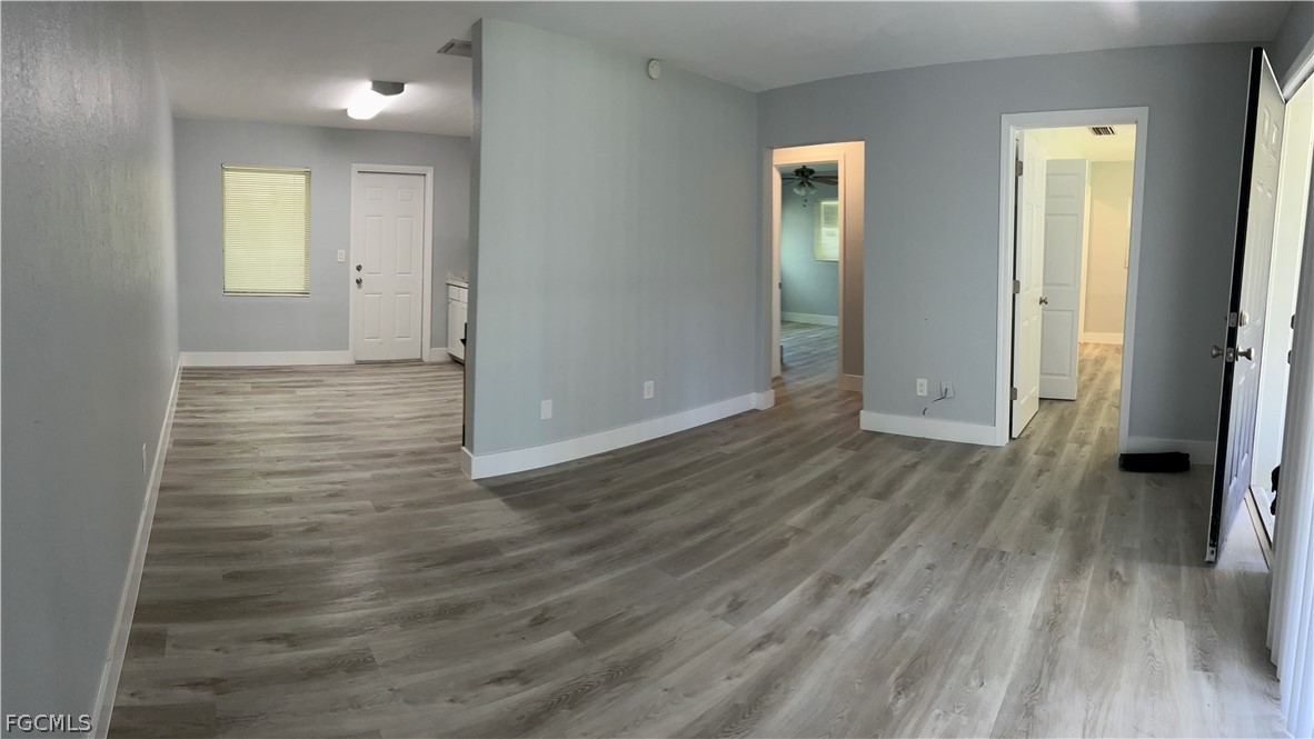 337 Tudor Drive, Unit R Cape Coral, FL 33904 - Photo 5 of 13 a view of a hallway with wooden floor and closet area