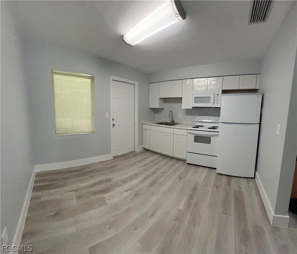 337 Tudor Drive, Unit R Cape Coral, FL 33904 - Photo 8 of 13 a room with window and white cabinets