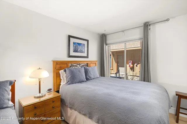 a bedroom with a bed and a night stand