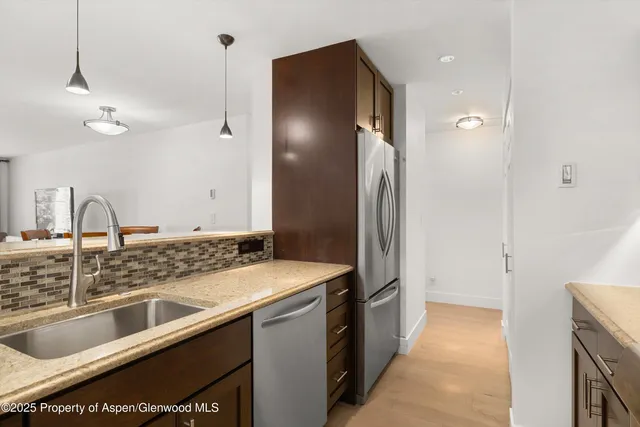 a kitchen with a sink and a refrigerator