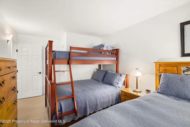 a bedroom with two beds and painted walls