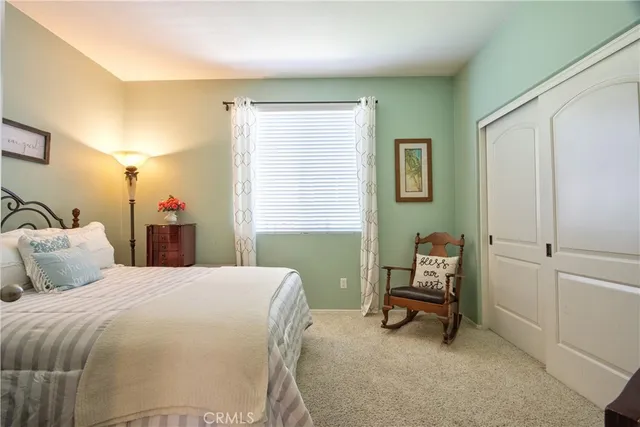 a bedroom with a bed a desk and chair