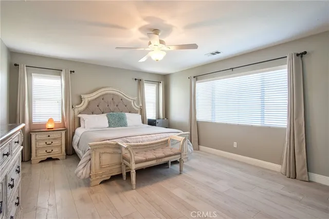 a bedroom with a large bed and a chandelier