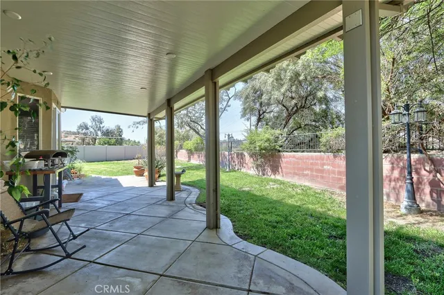 a view of a porch with chairs and backyard