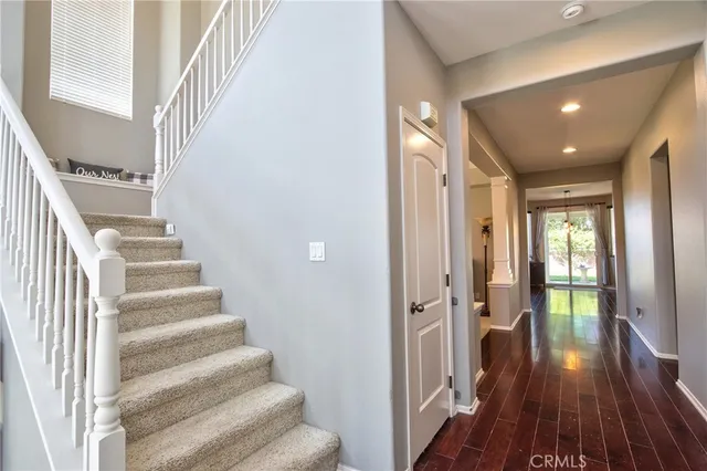 a view of entryway with wooden floor and stairs