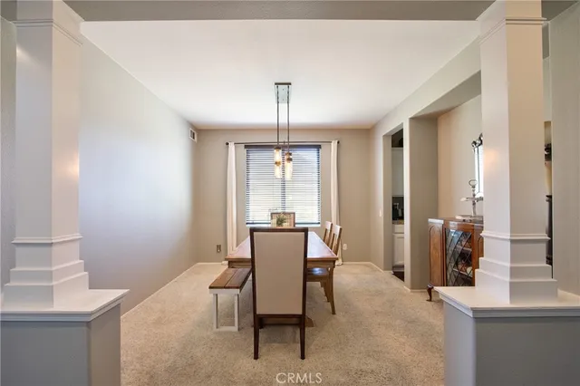 a dining room with furniture and window