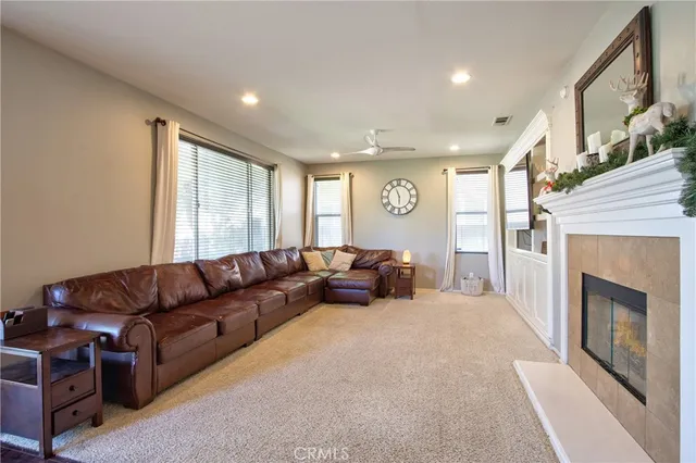 a living room with furniture a fireplace and a large window