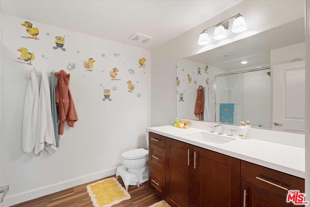 12883 West Runway Road, Unit 1 Playa Vista, CA 90094 - Photo 26 of 36 a bathroom with a sink a toilet and a mirror
