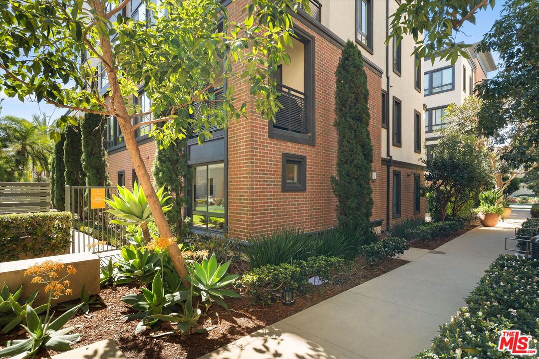 12883 West Runway Road, Unit 1 Playa Vista, CA 90094 - Photo 30 of 36 a yellow building with trees in front of it