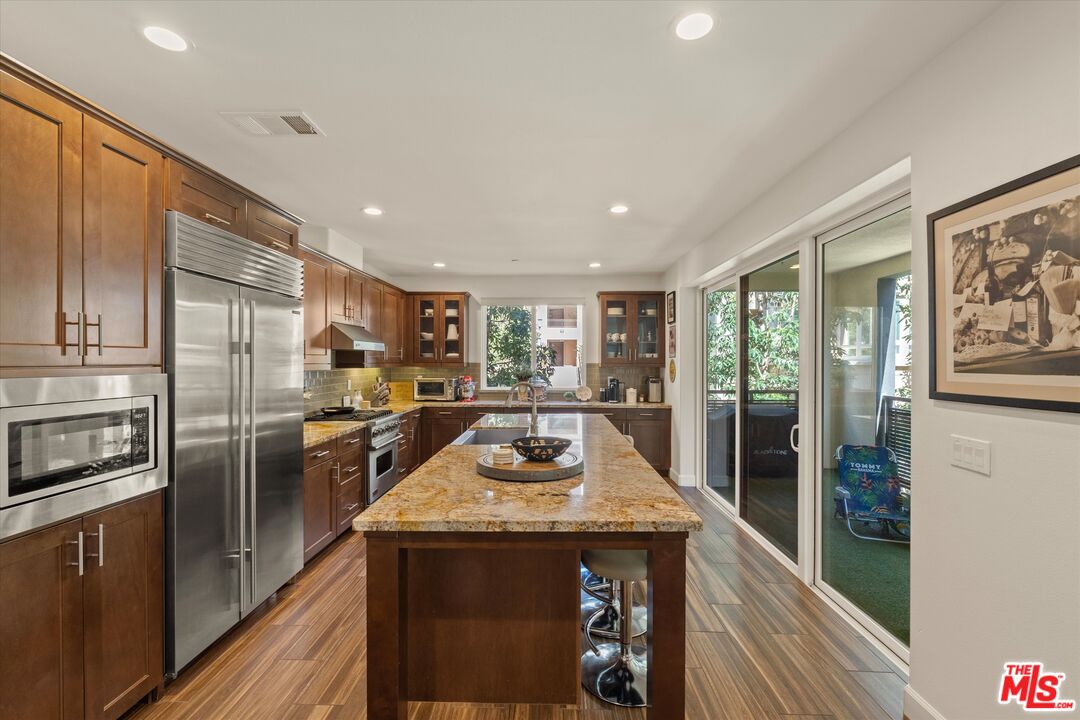 12883 West Runway Road, Unit 1 Playa Vista, CA 90094 - Photo 7 of 36 a kitchen with stainless steel appliances granite countertop a refrigerator a stove and a refrigerator