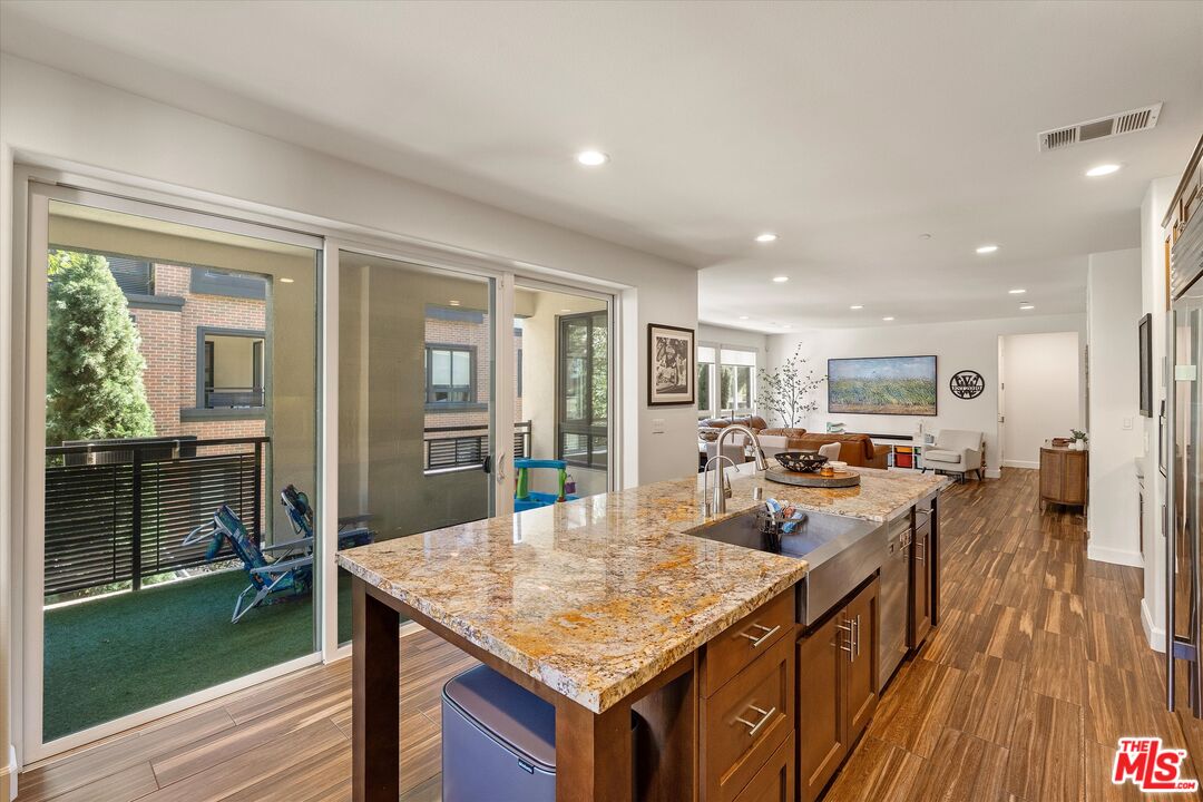 12883 West Runway Road, Unit 1 Playa Vista, CA 90094 - Photo 9 of 36 a kitchen with counter top space and wooden floor