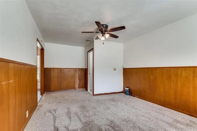 an empty room with a ceiling fan