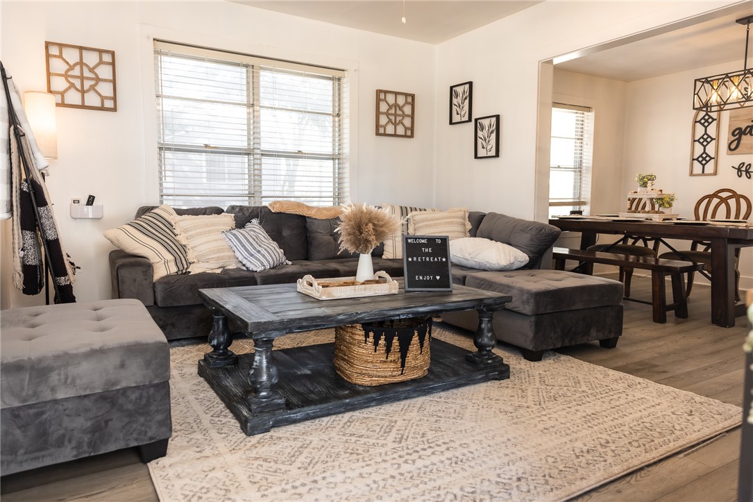 1308 Antone Street Bryan, TX 77803 - Photo 2 of 36 a living room with furniture a wooden floor and a large window