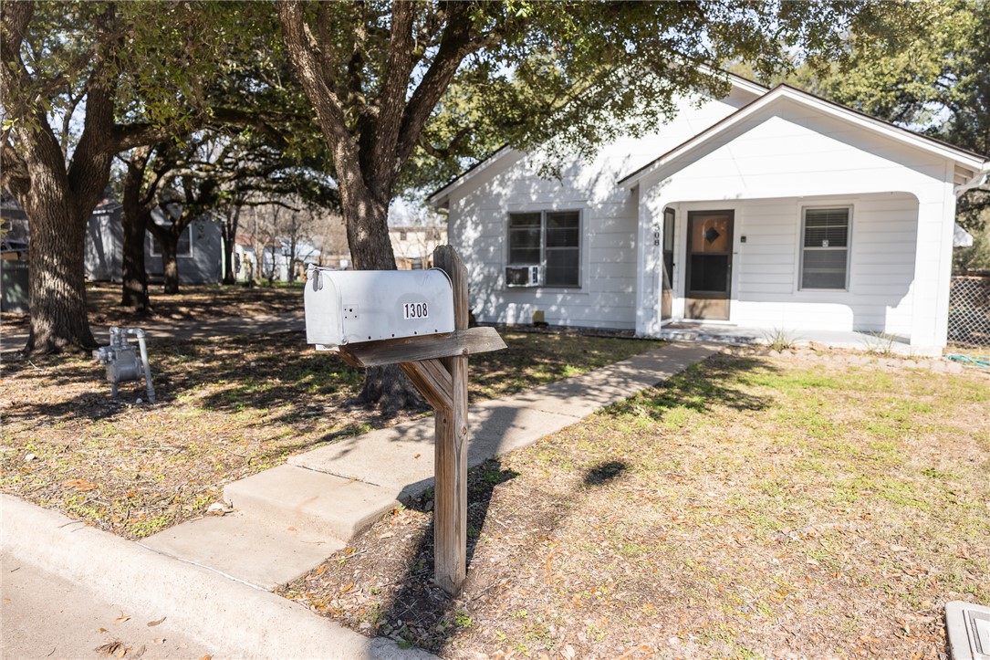 1308 Antone Street Bryan, TX 77803 - Photo 32 of 36 a wooden bench sitting in front of a house