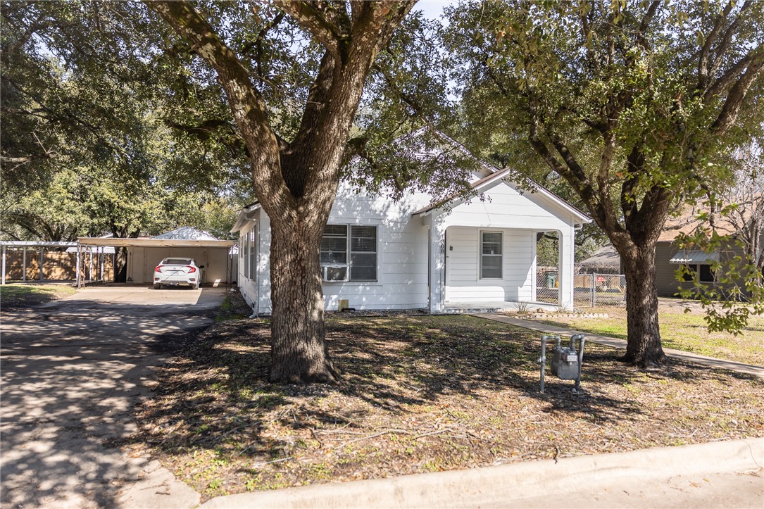 1308 Antone Street Bryan, TX 77803 - Photo 33 of 36 a front view of a house with yard tree and wooden fence