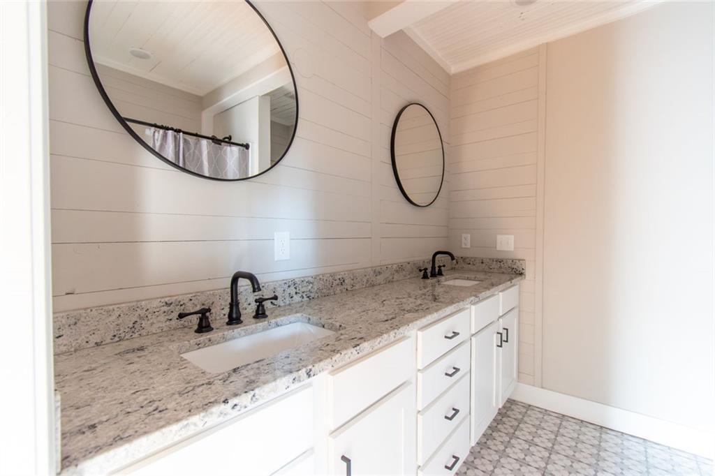 702 Radford Street Monroe, GA 30655 - Photo 35 of 49 a bathroom with a sink and a mirror