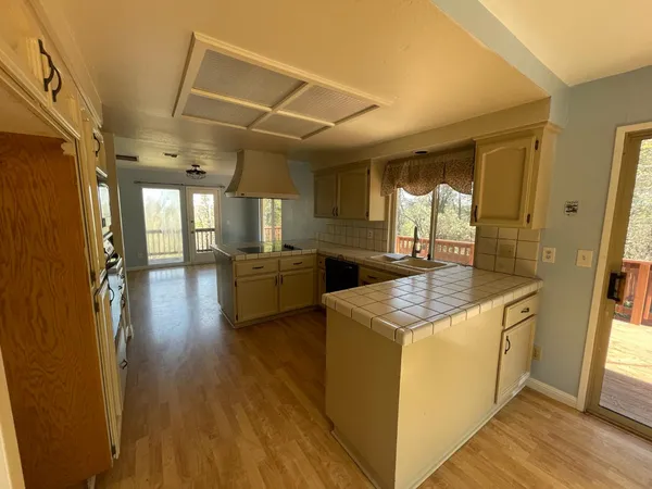 a kitchen with stainless steel appliances granite countertop a sink and cabinets