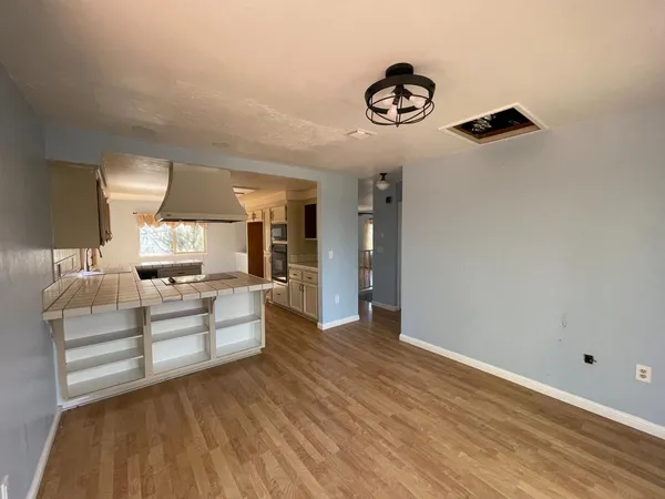 a kitchen with kitchen island white cabinets and stainless steel appliances
