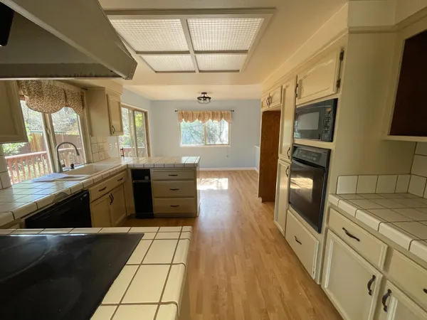 a kitchen with stainless steel appliances granite countertop a stove a sink and a refrigerator