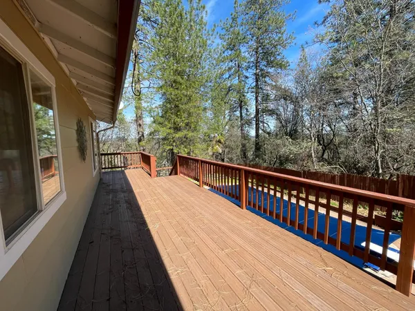 a balcony with wooden floor and outdoor space