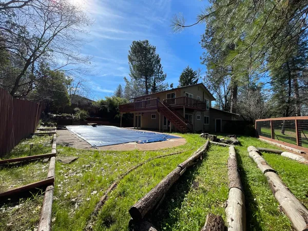 a view of a swimming pool with a yard