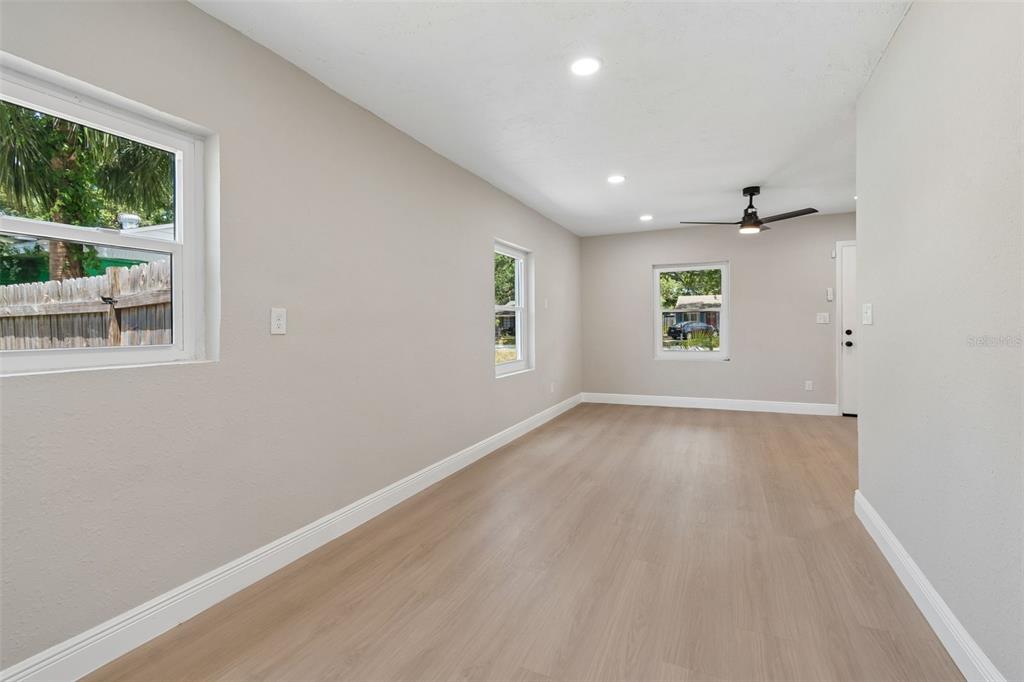 3912 West Pine Street Tampa, FL 33607 - Photo 14 of 60 an empty room with a window and wooden floor