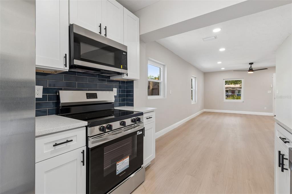 3912 West Pine Street Tampa, FL 33607 - Photo 18 of 60 a kitchen with a stove and a microwave