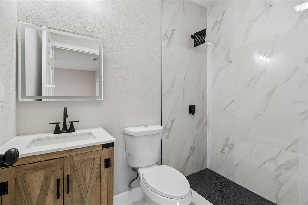 3912 West Pine Street Tampa, FL 33607 - Photo 28 of 60 a bathroom with a sink a toilet and shower