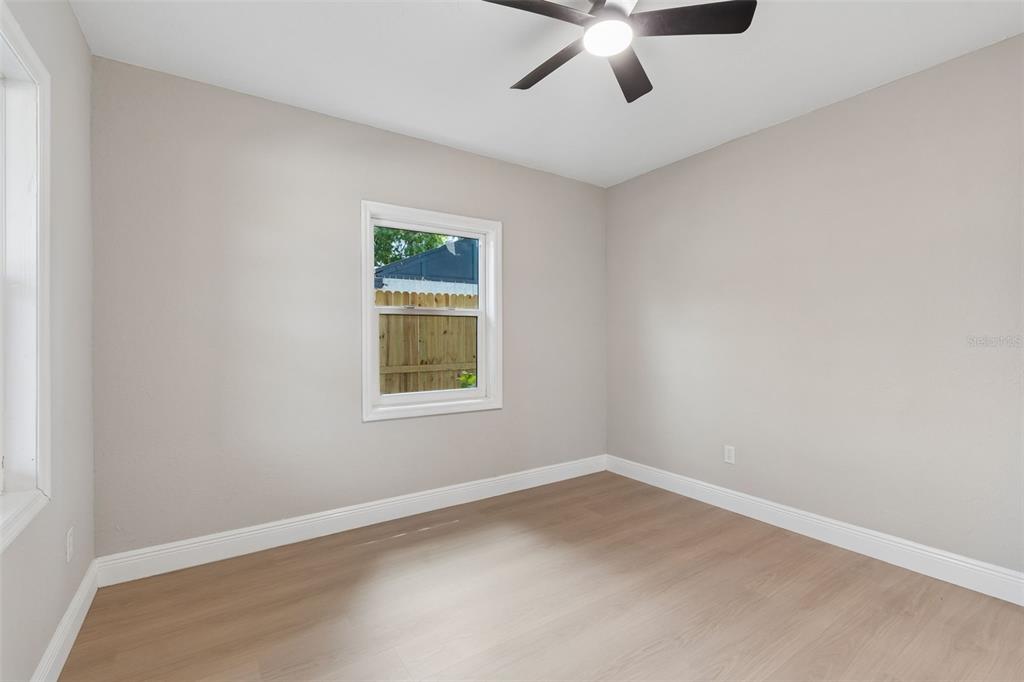 3912 West Pine Street Tampa, FL 33607 - Photo 33 of 60 an empty room with a window and ceiling fan