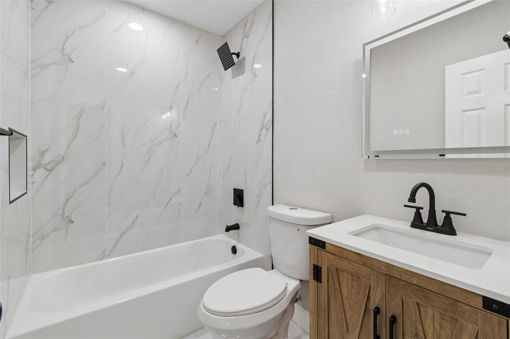 3912 West Pine Street Tampa, FL 33607 - Photo 34 of 60 a bathroom with a sink a toilet and a bathtub