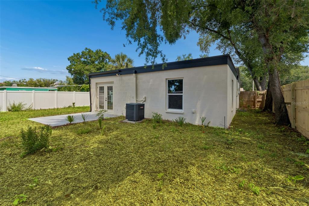 3912 West Pine Street Tampa, FL 33607 - Photo 45 of 60 a backyard of a house with lots of green space and lake view