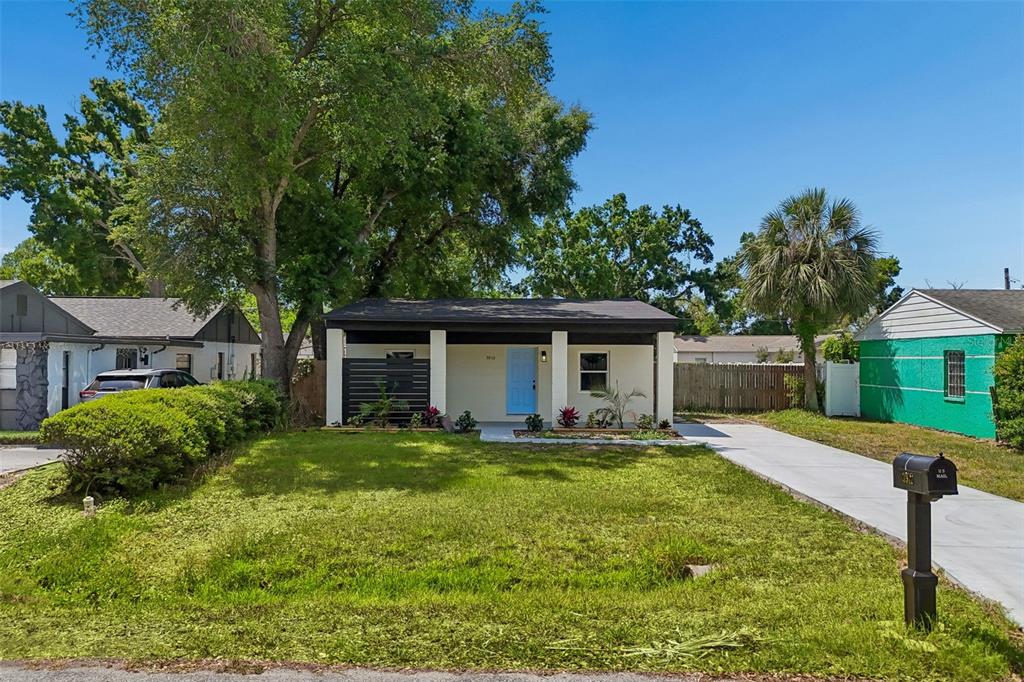 3912 West Pine Street Tampa, FL 33607 - Photo 48 of 60 a front view of a house with a yard and trees