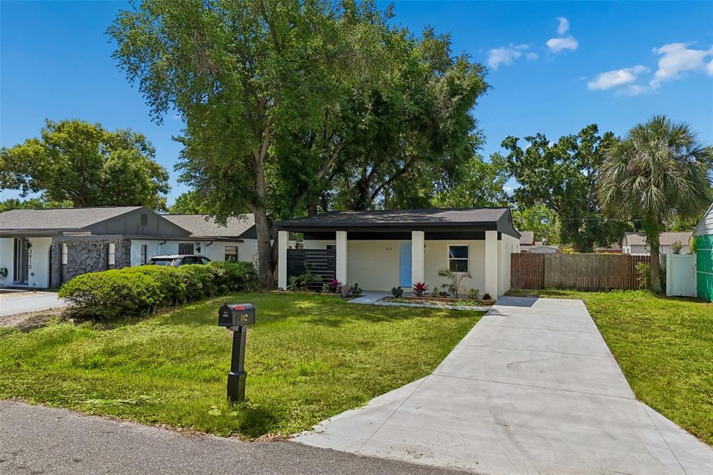 3912 West Pine Street Tampa, FL 33607 - Photo 49 of 60 a front view of a house with a garden and trees