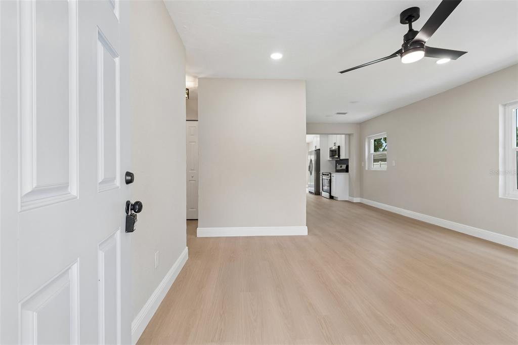 3912 West Pine Street Tampa, FL 33607 - Photo 6 of 60 a view of a hallway with wooden floor and chandelier fan