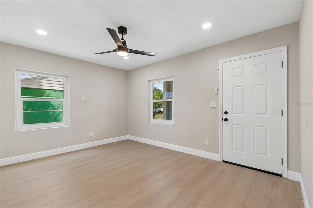 3912 West Pine Street Tampa, FL 33607 - Photo 8 of 60 a view of an empty room with wooden floor and a window