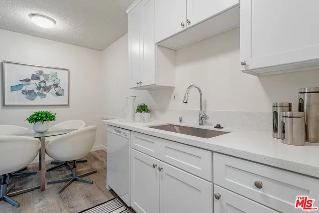 a kitchen with a sink cabinets and dining table