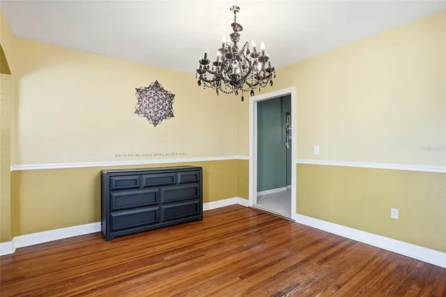 a view of room with wooden floor