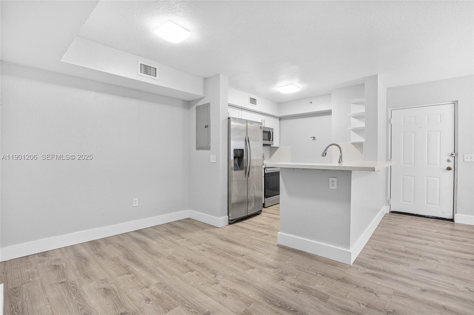 15410 Southwest 284th Street, Unit 8208 Homestead, FL 33033 - Photo 1 of 20 a view of a kitchen with wooden floor and electronic appliances
