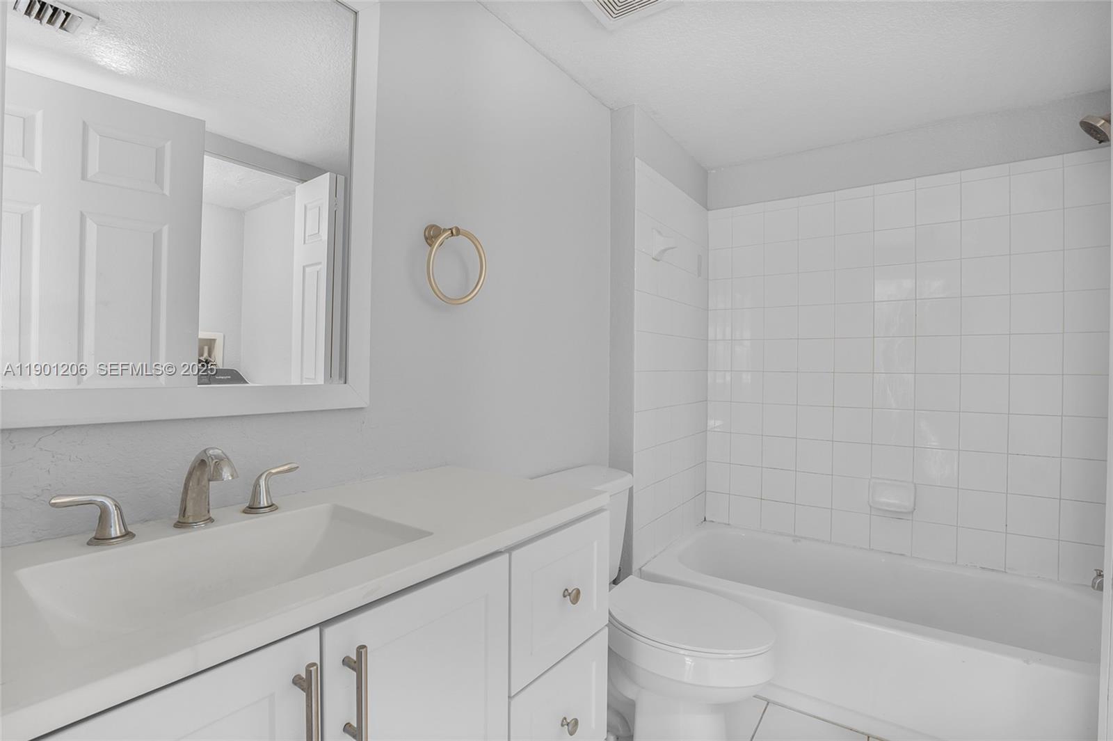 15410 Southwest 284th Street, Unit 8208 Homestead, FL 33033 - Photo 14 of 20 a bathroom with a sink and a bathtub